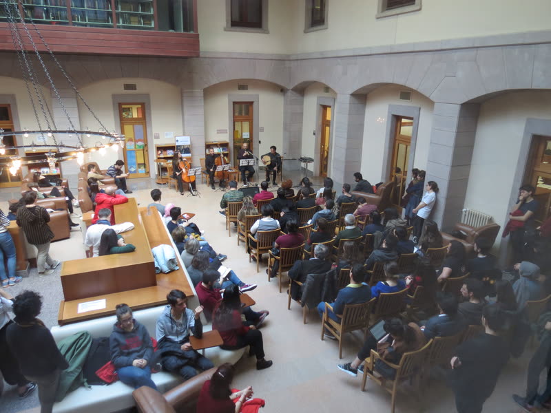 Audience filling a vaulted hall