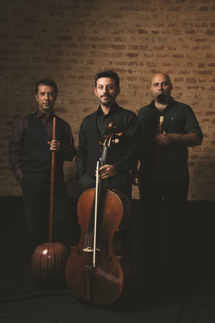 Murat Aydemir, Çağ Erçağ and Ertan Tekin with their instruments in front of a brick wall
